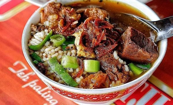 Bowl of Nasi Grombyang beef soup with rice